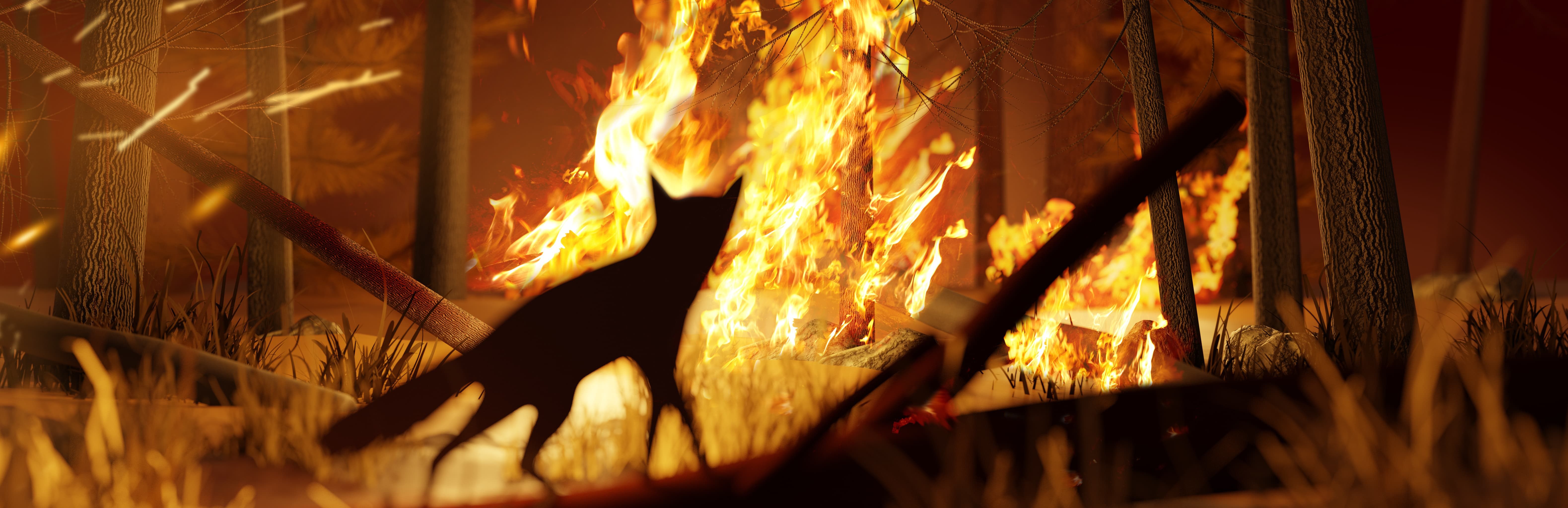 Onlooking fox watching as fire grows in a forest